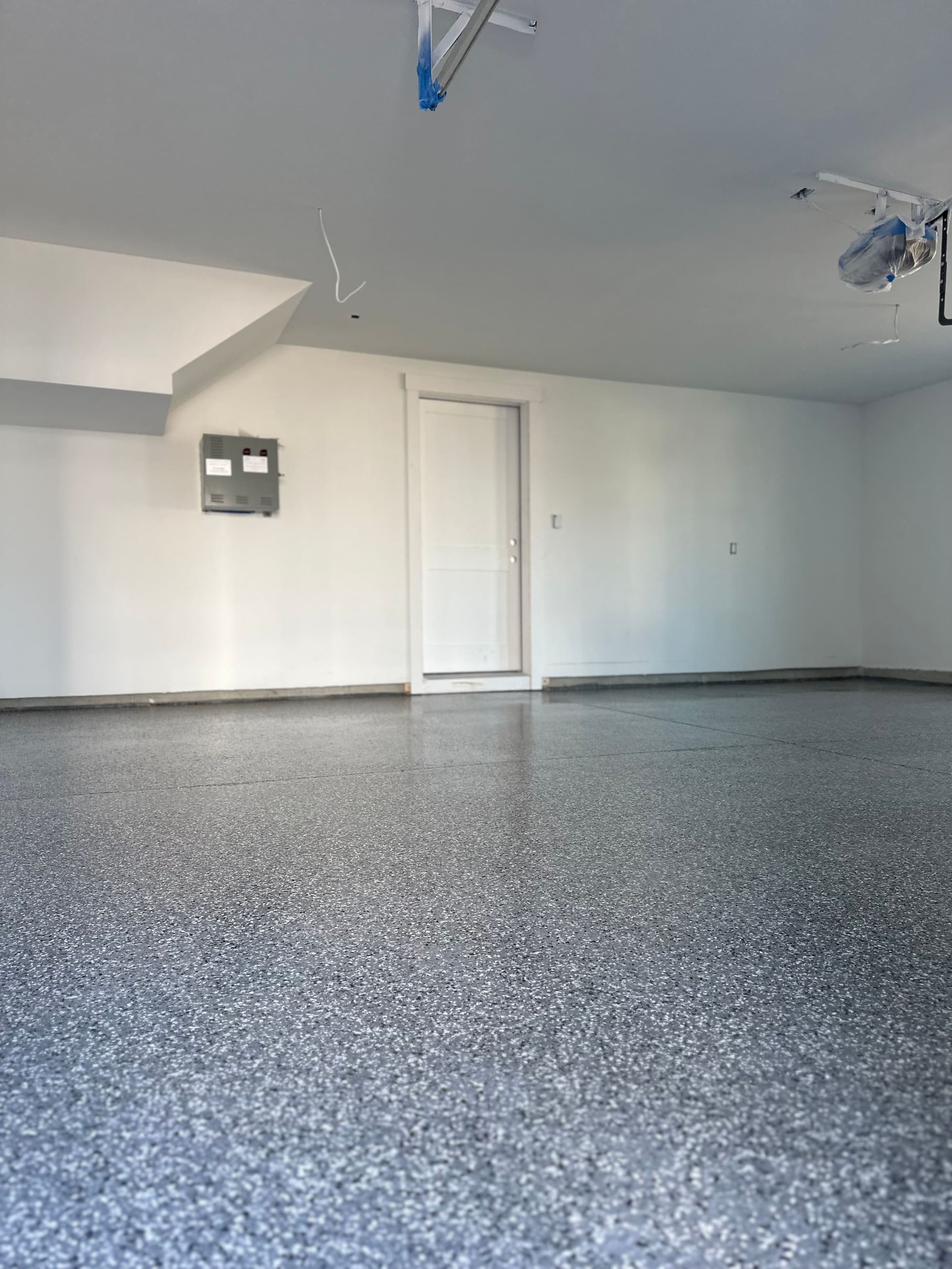 Finished lower-level room with flake floor